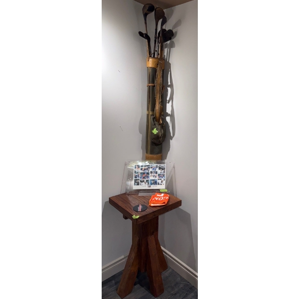 Vintage Golf Bag Set Positioned On A Wooden Pedistal