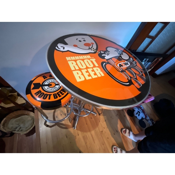 A&W vintage style tall round table with two stools .