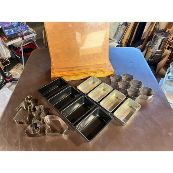 Oak recipe stand with protective glass, mini cake pans, honeycomb cutter, and assorted cookie cutter