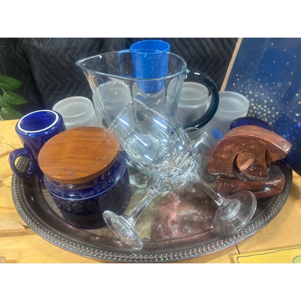 Household Items Including Wooden Hangers, Glassware, and Ceramic Trivets
