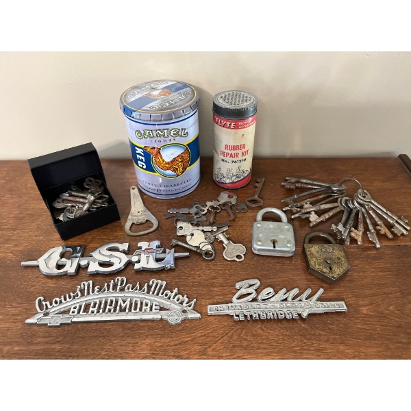 Vintage car dealership signs several antique keys and locks as well as a camel tin and a antique rub
