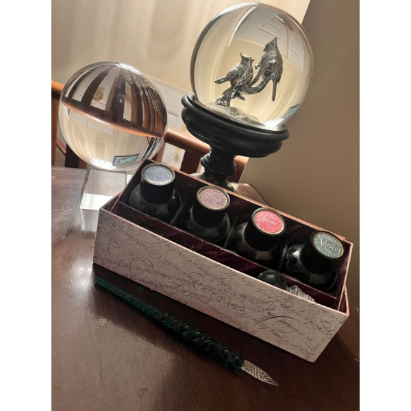  Vintage style calligraphy, ink, and pen set with crystal globe on a pedestal and a bird snow globe 