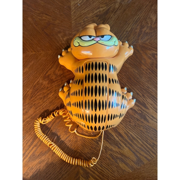 1986 Garfield Wall Phone
Collection of vintage sports items juggling set rollerskates baseball mitts