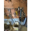 Image 7 : pegboard with various tools, including bolt cutters gear, polars, hacksaw, bungee cords, vice grips,