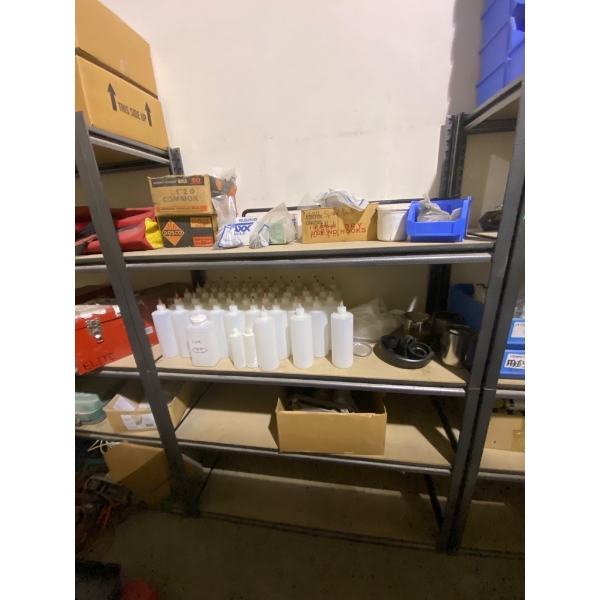 Storage Shelf With Contents Including Plastic Bottles, Nails, and Tools