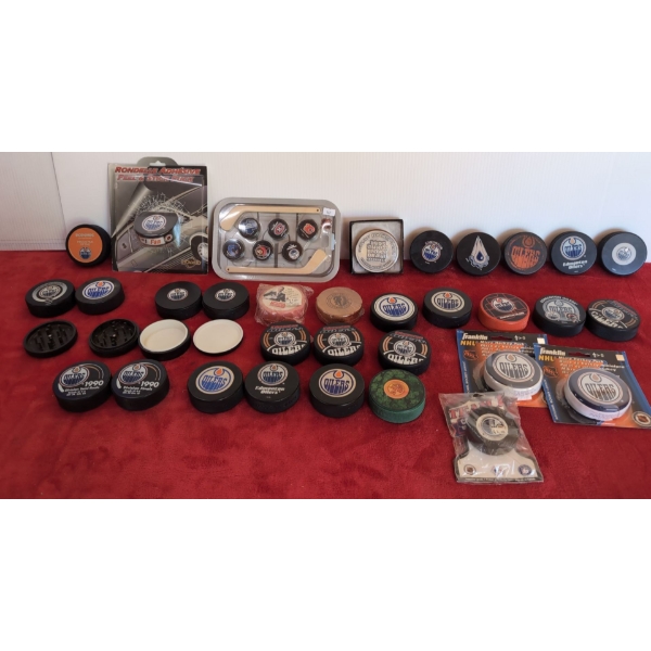 Various Oilers Pucks, Oilers Grinder Puck and Storage Pucks