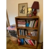 Large collection of cookbooks shelves included vintage cat picture, wicker basket, and three blanket