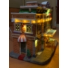 Image 4 : Illuminating Holiday Homes: Nexxtec Walmart and Lemax Playhouse (Awning is Unglued) 