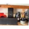 Image 4 : contents of shelf, including a GE garbage disposal, Kenwood speakers, rolling knee cart, laser level