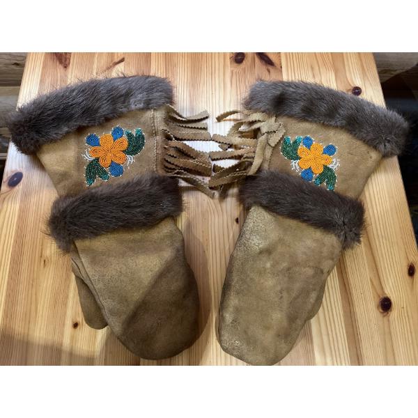 Hand Made leather and fur gloves with indigenous beef work on the front of the mitts