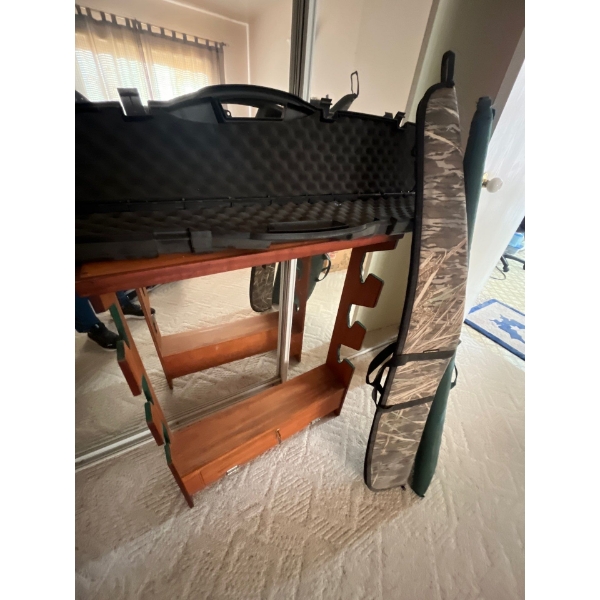  gun rack with two soft cases, and one hard case
