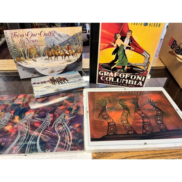 Assortment of Christmas cards from our outfit to yours, a photo album and two framed artwork from th