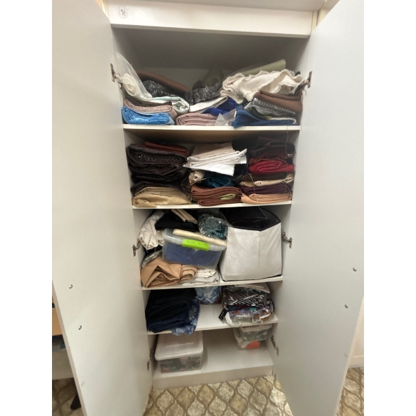 cabinet full of quilting material and a number of bolts of fabric