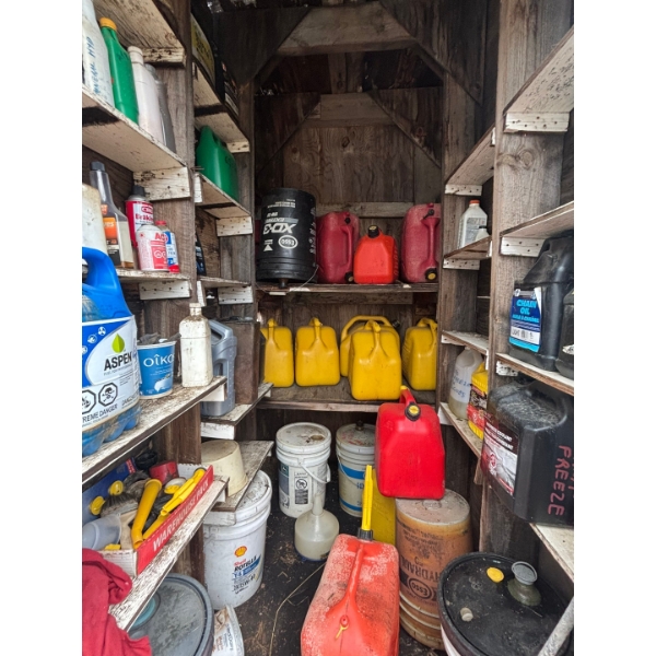 several barrels of oil, gas cans, both diesel and unleaded vintage oil cans. 