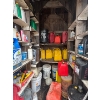 Image 1 : several barrels of oil, gas cans, both diesel and unleaded vintage oil cans. 