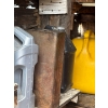 Image 2 : several barrels of oil, gas cans, both diesel and unleaded vintage oil cans. 
