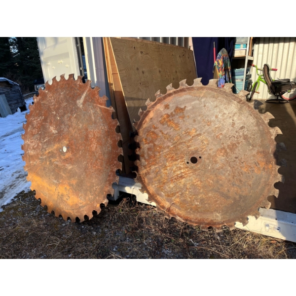 two massive sawmill saw blades circular 143 inches and 147 inches