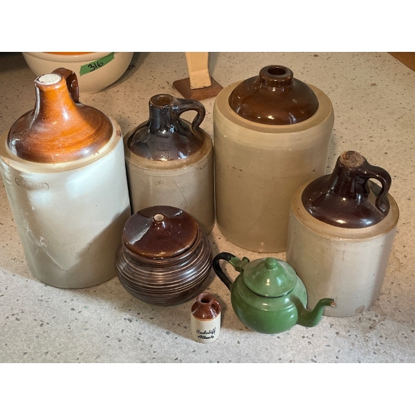 4 antique whiskey jugs with two small Medalta pieces of vintage pottery and a vintage green enamel t
