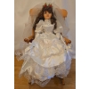 Image 1 : Porcelain Doll in White on a Rocking Chair (Chair Needs TLC) - 26T
