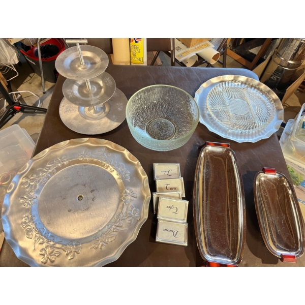 Large cake swivel display, small frames for name tags on tables, an assortment of serving dishes