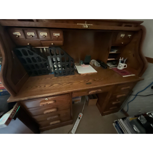 Beautiful oak Roll Top Desk and rolling oak chair in great condition with several storage drawers an