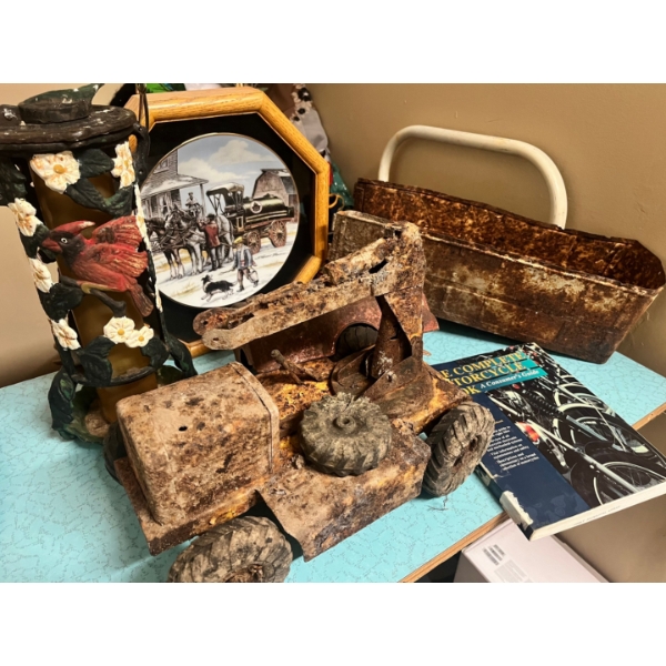 Cast iron bird feeder, LFA collectors plate, The complete motorcycle book, and vintage toys