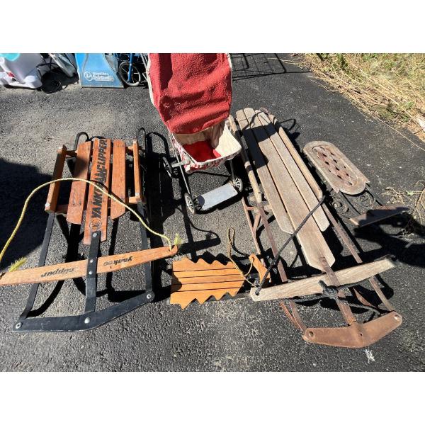  Collection of vintage and vintage style sleds with small baby carriage .