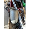 Image 3 : number of miscellaneous items, vintage gas cans, several funnels, vintage milk, jug, and vintage can