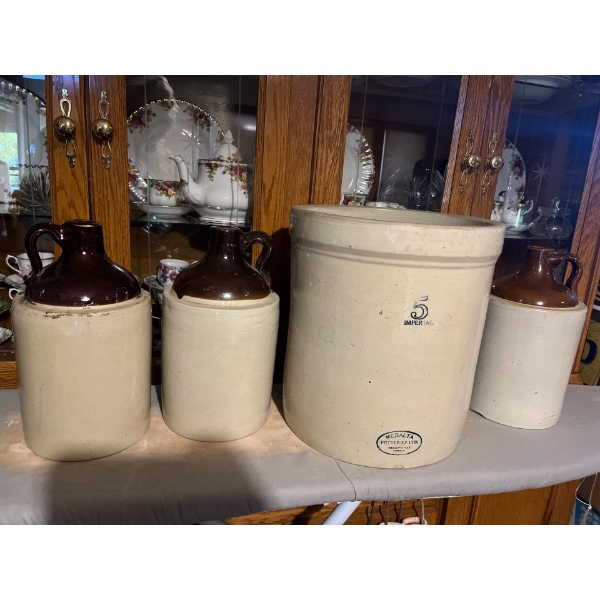  collection of whiskey, jugs and a number five imperial
Medelta crock made in Alberta