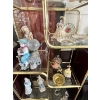 Image 3 : Collection of vintage figurines, dolls, and decorative items displayed on a brass and glass etagere,