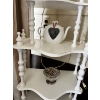 Image 4 : Vintage white corner shelf unit is styled in a French Provincial or shabby chic aesthetic. 