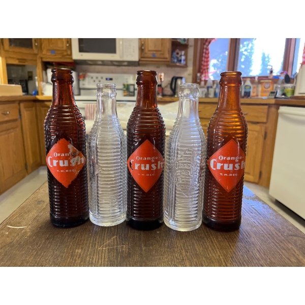 Collection  of clear and brown Orange crush bottles. All in good condition 
