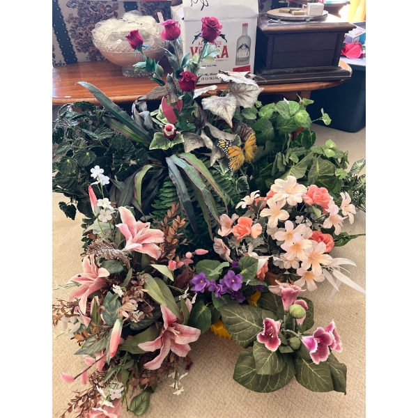 Variety of silk plants and flowers .