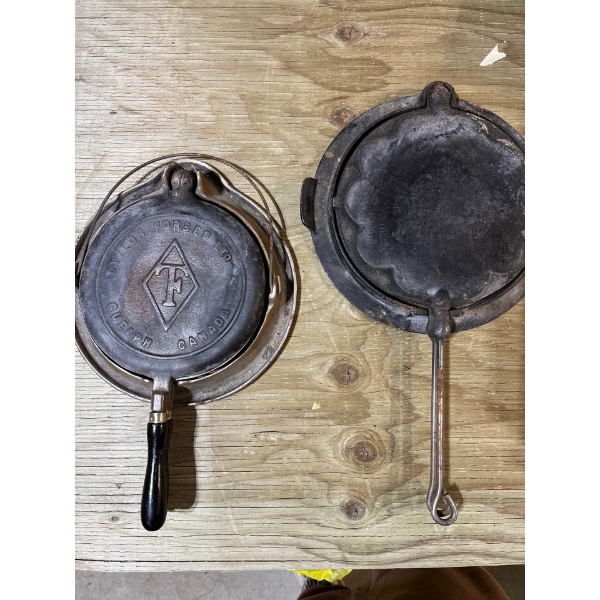 two vintage cast-iron waffle irons one is marked Taylor Forbes Limited, Guelph Canada