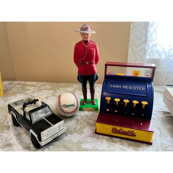 a vintage Tonka pressed steel toy truck, vintage plastic figurine of a Royal Canadian Mounted Police