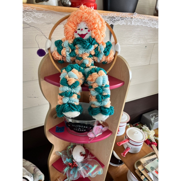 80s yarn clown with corner shelf and assorted faux flowers 

