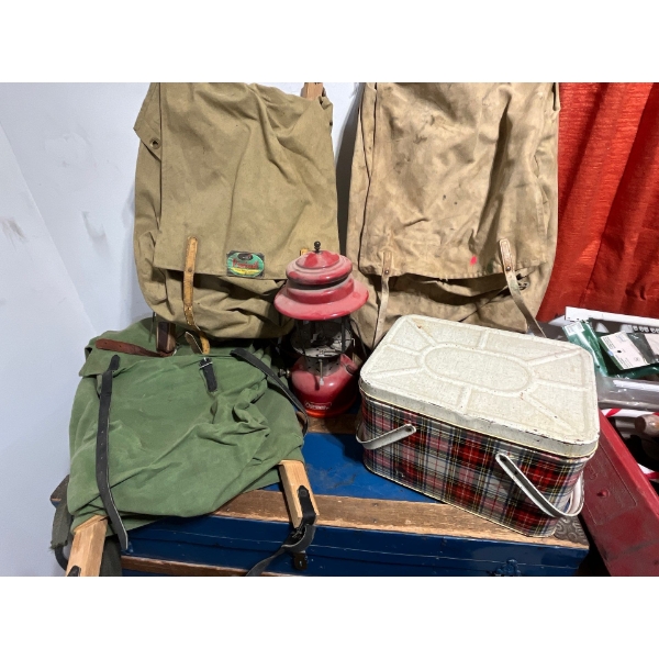 Three original Alberta forestry backpacks, Coleman lantern, and a plaid vintage metal lunch kit