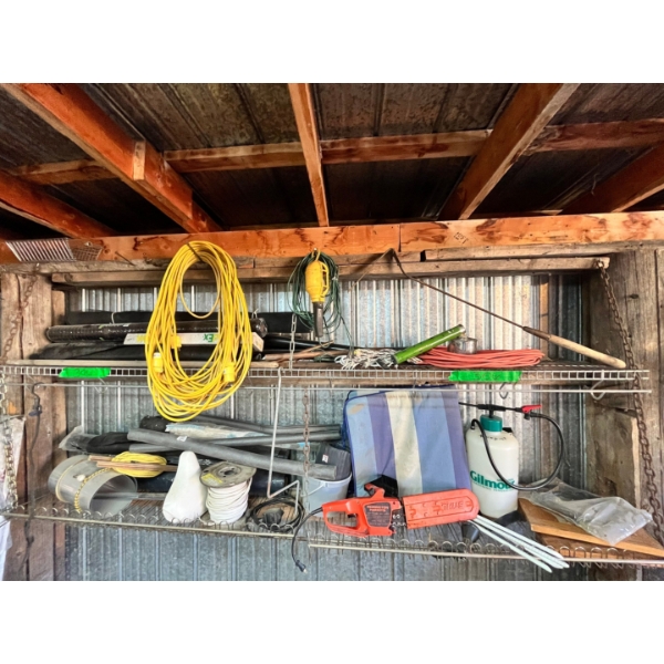 2 shelves filled with treasures. Copper pipe pieces, garden weed barrier, extension cords, + MORE