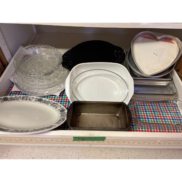 Lot of serving trays, serving bowls, pie plates, bread pans made by Pyrex, including Pyrex loaf, pan