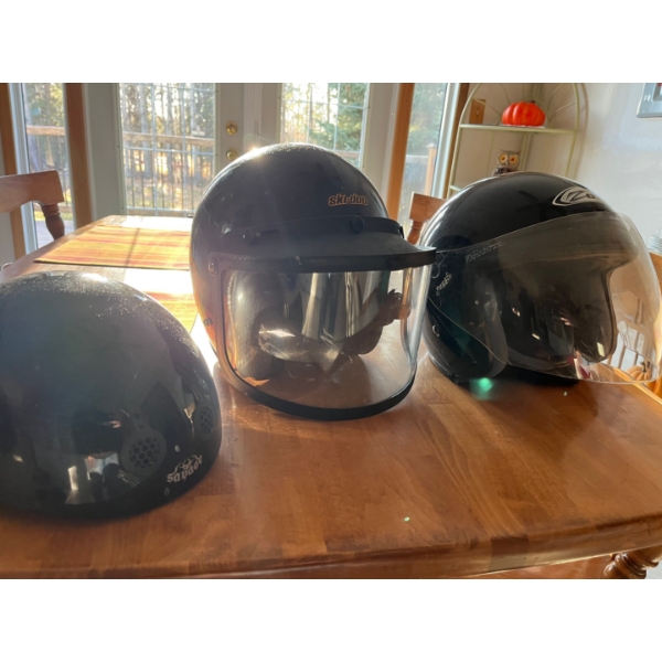  three front face helmets, one vintage skidoo helmet