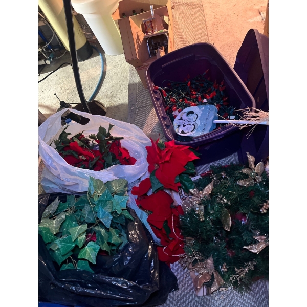  huge Rubbermaid filled with red Christmas lights of poinsettias, two Christmas wreaths, some green 