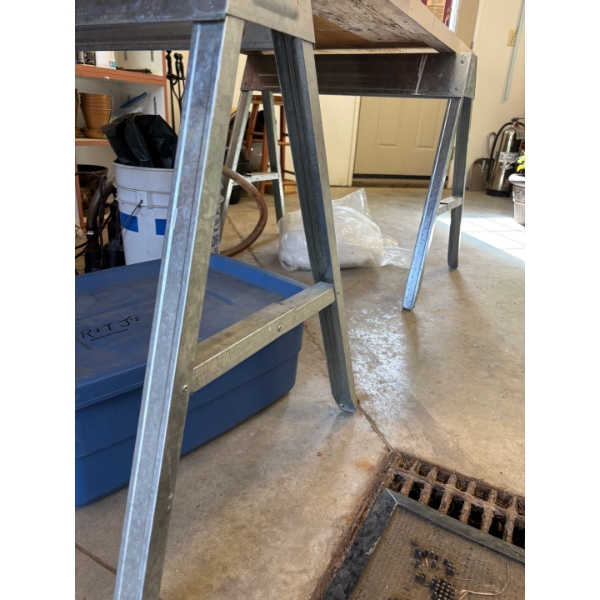 Two aluminum sawhorses and table top