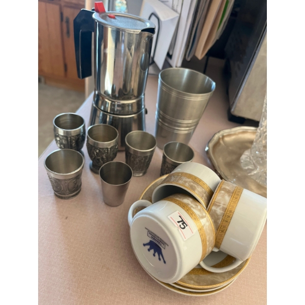 Individual size coffee maker with five small shot glasses and a set of three cappuccino cups and sau