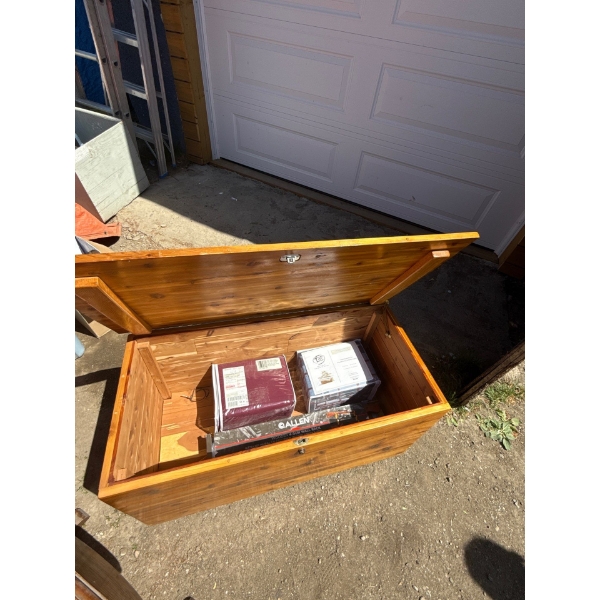 Wooden chest, bed sheets, wooden gun rack