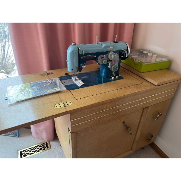 vintage arrow, super automatic, sewing machine with accessories, sewing desk and several bobbins of 