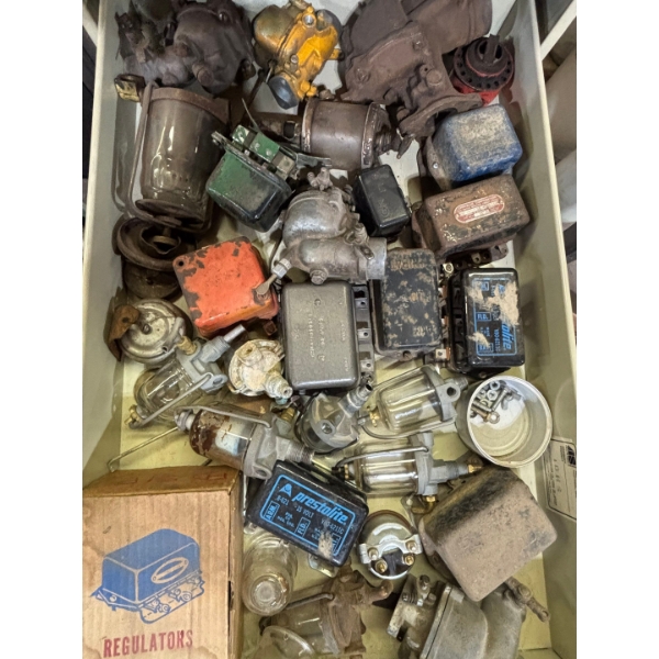 Several vintage tracker parts carburetor's regulators, & number of other items great collector