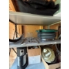 Image 2 : Metal shelf with hose mosquito net numerous disposable cups plates, forks knives, as well as several