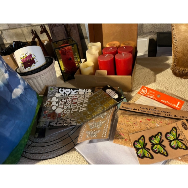 large collection of crafting supplies and several candles along with flower pots and a candle holder