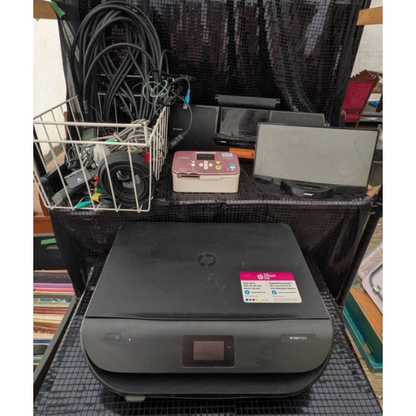 Electronic Devices with Assorted Cables, Including HP Printer, Canon Printer, and Bose Sound Systems