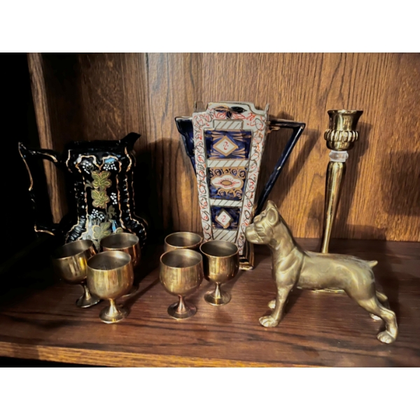 Ornate tea pots, and six small brass cups brass dog and candle holder